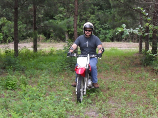 a large man on a small motorcycle